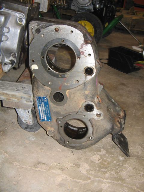 1978 Ford Bronco - Transmission housing with a blue data plate attached, showing some mechanical components in the background.