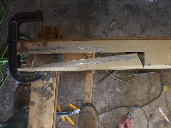 Metal part clamped and cut, with tools and work area visible