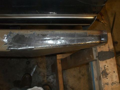 1995 Ford Bronco - This photo shows a vehicle bumper that has been ground down, likely in preparation for bodywork or repair.