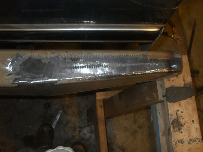 Close-up of a vehicle bumper with grinding marks from repair work