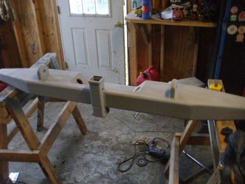 1995 Ford Bronco - Aftermarket bumper with hitch receiver and tow hooks, painted light tan and resting on sawhorses.
