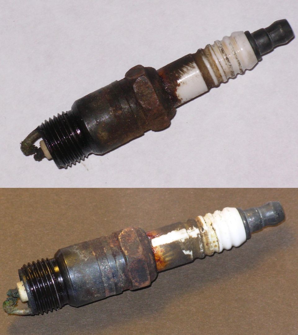 Two used spark plugs shown in comparison, both fouled and corroded