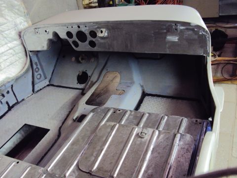 1948 Jeep Wrangler - The interior of a vehicle is shown, with the floor pan and dashboard area exposed for restoration work.