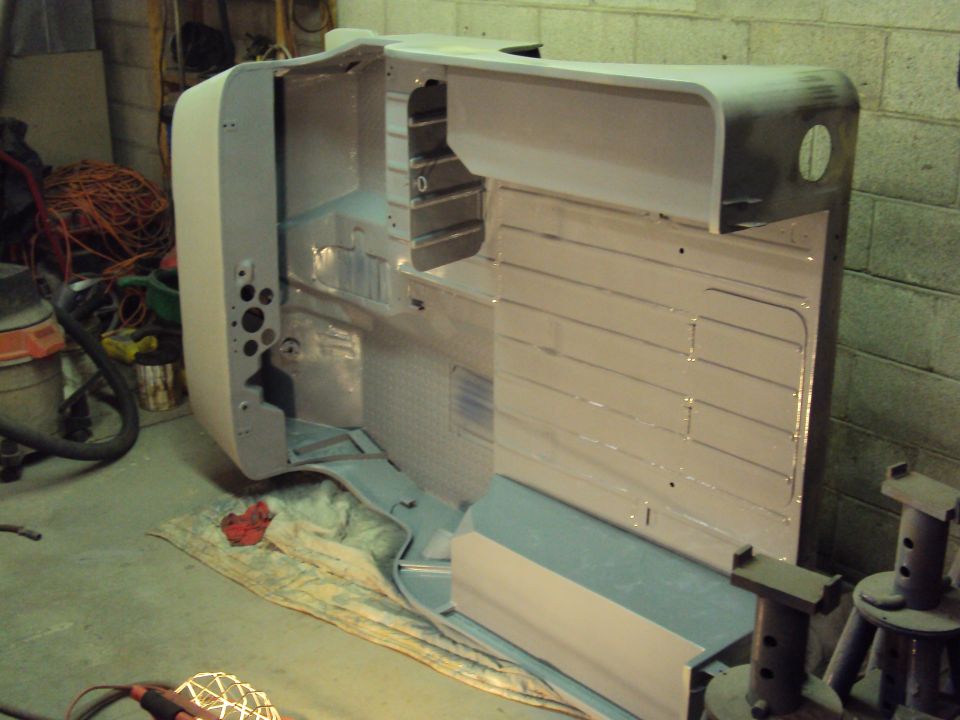 Gray vehicle body tub on sawhorses, interior visible