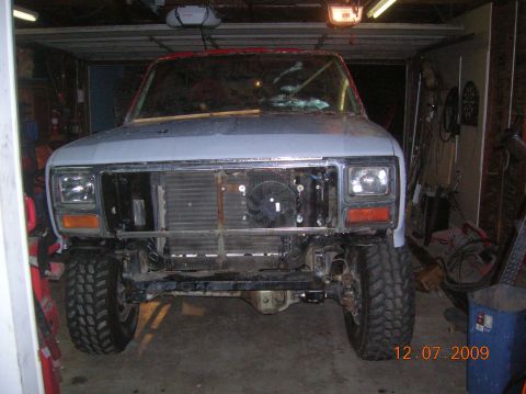 1985 Ford Bronco - This Ford Bronco is in a garage, likely undergoing a rebuild or repair process.