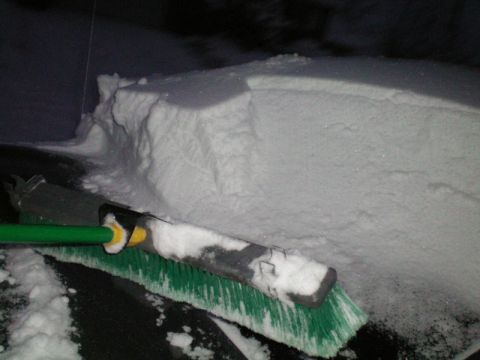 2003 Ford Taurus - A snow brush is used to clear snow from a vehicle's hood and windshield during a winter storm.