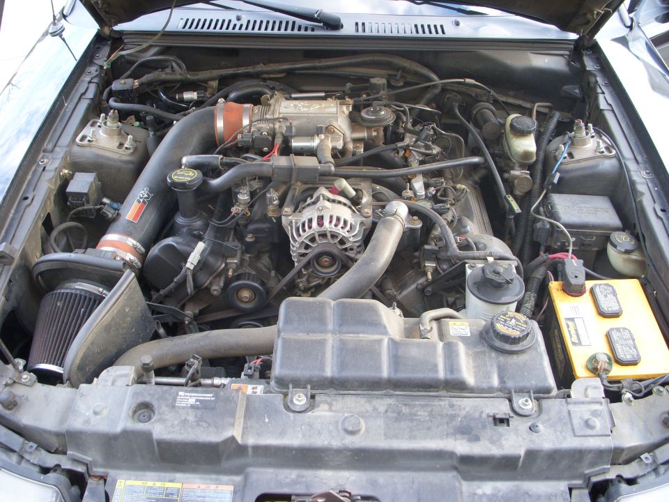 Engine bay with K&N air intake and yellow battery
