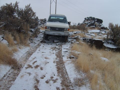 1989 Ford Bronco - A 1987 Ford Bronco navigates a snowy and rocky off-road path.