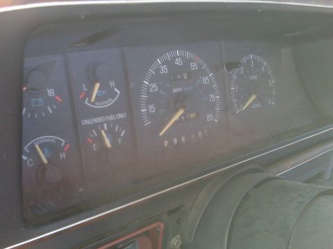 1989 Ford Bronco - Close-up of a vehicle's dashboard gauges, showing speedometer, fuel, and RPM indicators.