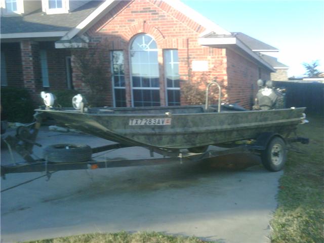 Camouflaged boat on trailer with TX license plate