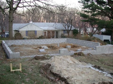 1996 Ford Bronco - Construction site shows a house foundation in progress with cinder block walls and piles of dirt.