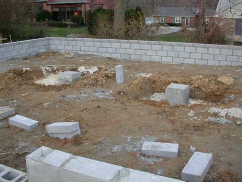 1996 Ford Bronco - A construction site shows the beginnings of a foundation with cinder blocks and disturbed earth.