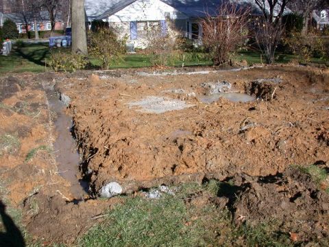1996 Ford Bronco - Construction site with trenches and puddles in front of a house.