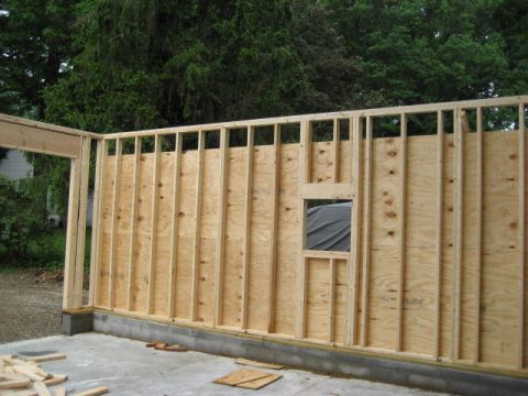 1996 Ford Bronco - Construction of a garage is underway, showing the exposed wooden framing and plywood walls.