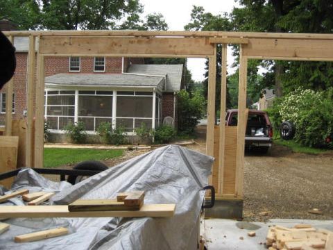 1996 Ford Bronco - A red pickup truck is parked in the driveway of a house under construction.