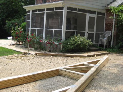 1996 Ford Bronco - A screened porch is visible next to a house, with roses and lumber in the foreground.