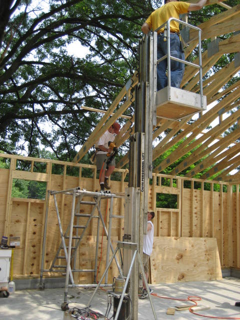 1996 Ford Bronco - Workers are actively engaged in building construction, utilizing specialized equipment for elevated access.