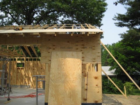 1996 Ford Bronco - A construction site shows the framing of a building with plywood sheets and scaffolding visible.