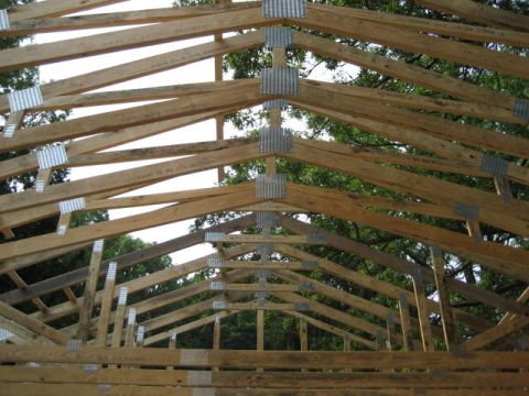 1996 Ford Bronco - The framework of a building's roof is assembled using wooden trusses and metal connectors.