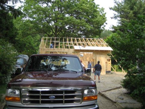 1996 Ford Bronco - A maroon truck is parked in front of a house under construction.