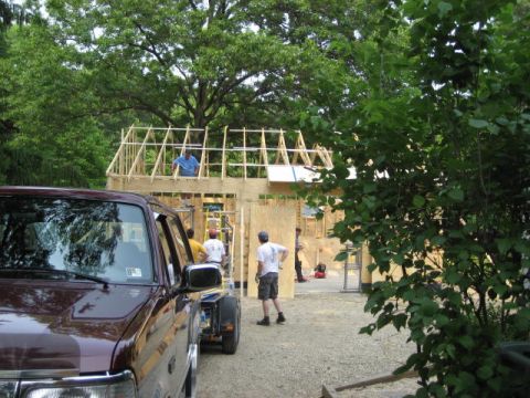 1996 Ford Bronco - A maroon truck is parked in front of a house being built, with workers on the roof.