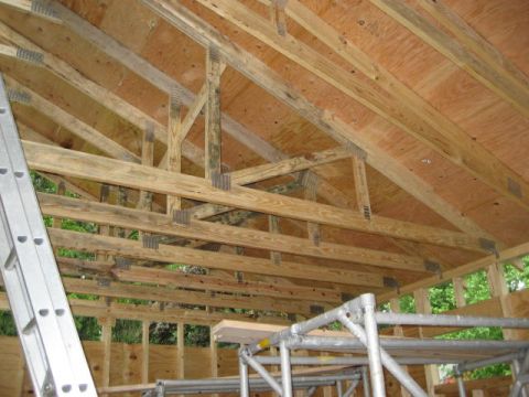 1996 Ford Bronco - Interior view of a building under construction, highlighting the roof structure and scaffolding.