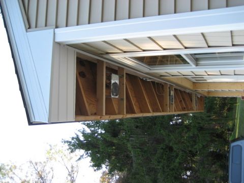 1996 Ford Bronco - House eaves under construction with exposed framing and siding visible.