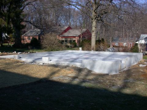 1996 Ford Bronco - A concrete foundation is laid out on a plot of land, with houses visible in the background.
