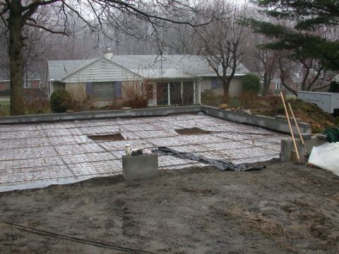 1996 Ford Bronco - A construction site is shown with a house in the background on a foggy day.