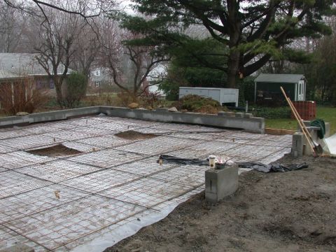 1996 Ford Bronco - A construction site shows rebar laid out on a plastic sheet, ready for a concrete foundation pour.