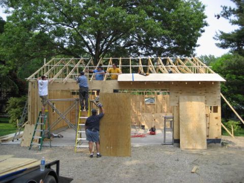 1996 Ford Bronco - Construction workers are actively building a garage, with framing and plywood visible.