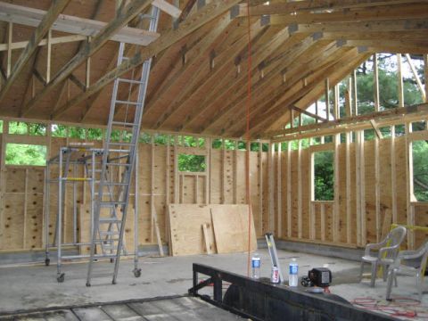 1996 Ford Bronco - The interior of a building is shown during its construction phase, with exposed wooden beams and walls.