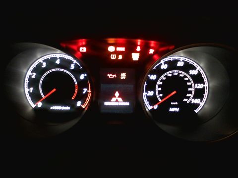 2010 Mitsubishi Outlander - Dashboard gauges and warning lights illuminated in a 2010 Mitsubishi Outlander.