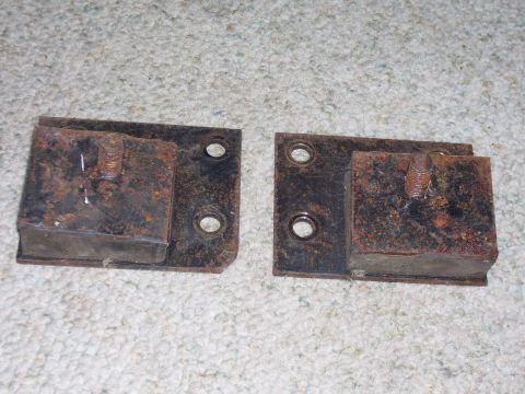 1979 Ford Pickup - Two rusty engine mounts are shown, each with a metal plate and a bolt.