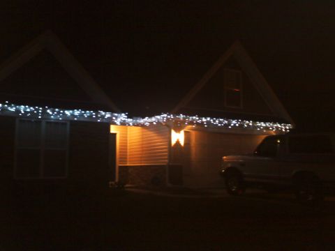 1977 Ford F-100 - Ford Bronco parked in front of a house decorated with Christmas lights at night.