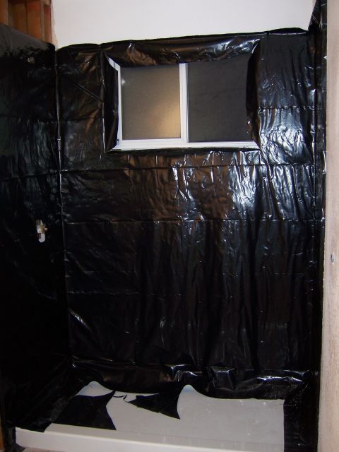 1991 Ford Bronco - Bathroom renovation in progress, showing plastic sheeting and a window over a bathtub.