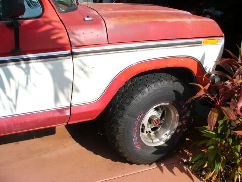 1995 Ford Bronco - This two-tone pickup truck features off-road tires and a two-tone red and white paint scheme.