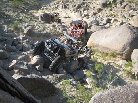 1992 Toyota Tacoma - Multiple off-road vehicles traverse a challenging rocky desert landscape.