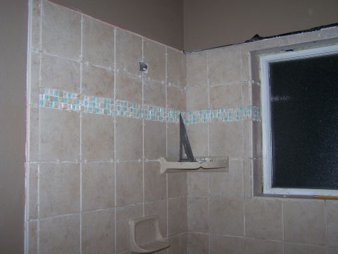 1991 Ford Bronco - Bathroom tiling project underway, showing a corner with a window and a soap dish.