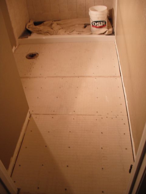 1991 Ford Bronco - Bathroom renovation in progress with subflooring and a bucket of supplies.