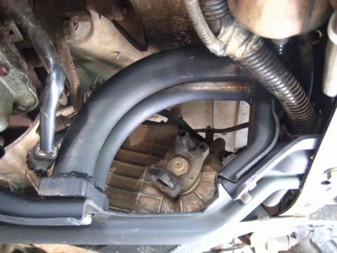 1989 Ford Bronco - Underside view of vehicle's exhaust manifold and transmission components, showing intricate mechanical details.