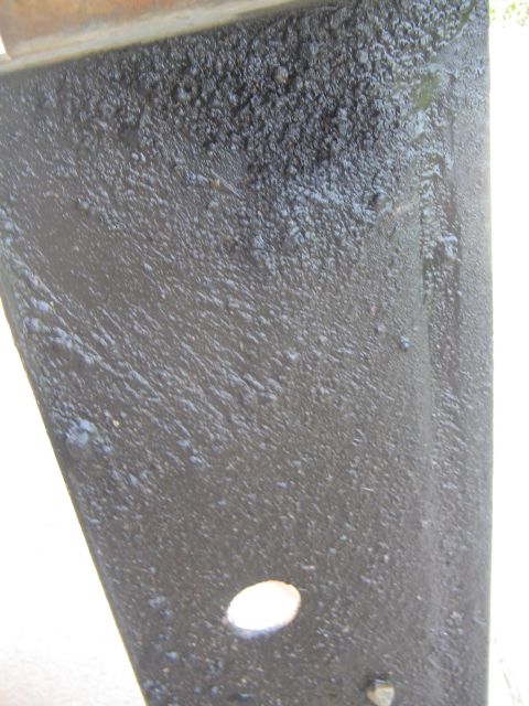 1978 Ford Bronco - This image shows a close-up of a vehicle's undercarriage, covered in grime and debris.