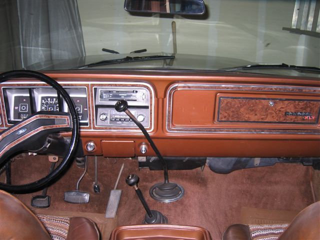1978 Ford Bronco interior showing dashboard, steering wheel, radio, and gear shifters