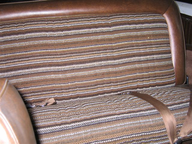 Close-up of a striped seat and seatbelt inside a vehicle