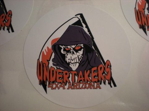Suzuki Samurai - Close-up of round white vinyl club decals printed with a purple-hooded grim reaper holding a scythe and red drip-style lettering reading "U…