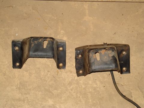 1991 Ford Bronco - Two used engine mounts are shown on a concrete floor.