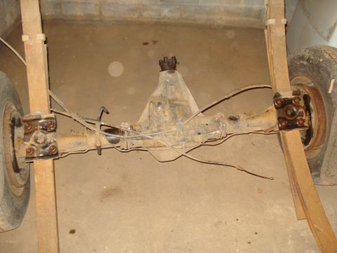 1991 Ford Bronco - Rear axle assembly with leaf springs and brake drum, likely removed from a vehicle.