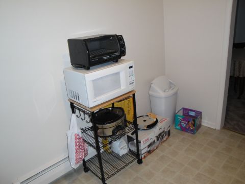 2000 Ford Crown Victoria - A kitchen scene a cart with various appliances and storage boxes.