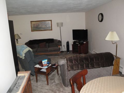 2000 Ford Crown Victoria - Interior view of a living room furnished with seating, a TV, and decorative items.