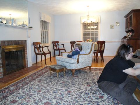 2000 Ford Crown Victoria - A living room scene with furniture and people, not a vehicle.